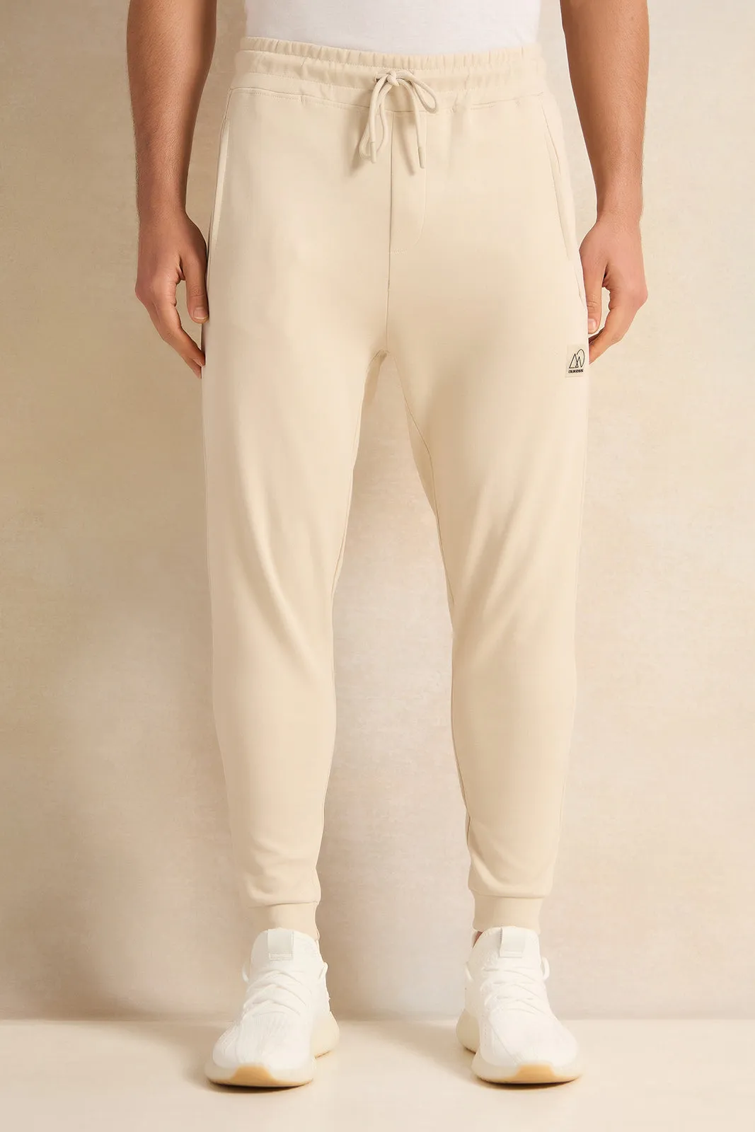 Men Beige Pleated Interlock Lounge Active Pants